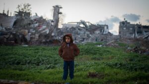boy-in-gaza-in-front-bombed-buildings-1200-800-1140x641